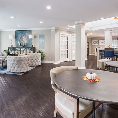 Leasing office furnished with 3 seperate seating areas each with tables and chairs at Azure Cove in Garden City, GA